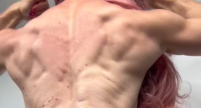 Biceps carved deep — stay down and admire the arm-wrestling strength.