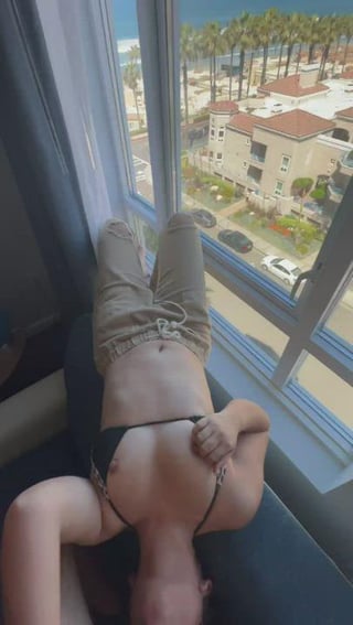 upside down sucking cock with the beach right outside the window